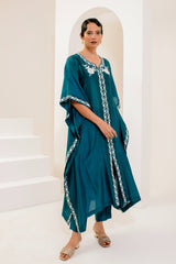 Teal blue kaftan adorned with intricate ivory thread embroidery